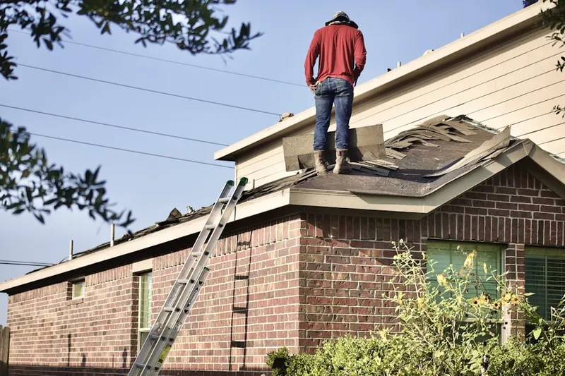 Professional roofer working on a residential roof in Hurdle Mills